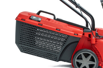 Close-up of the black grass catcher with a red lid of a lawn mower. With carrying handle and ventilation slots, isolated on a white background.