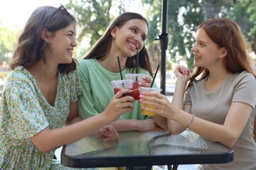 Friends enjoying refreshing drinks in outdoor cafe