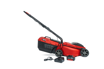 Fototapeta premium Lawn mower with accessories. Red cordless lawn mower with grass catcher, battery, and charger isolated on a white background. Complete set contents for gardening are visible.