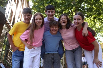 Portrait of happy teenage friends together outdoors. low angle view