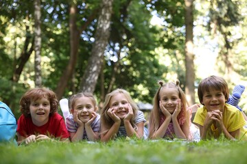 Cute little kids on green grass in park