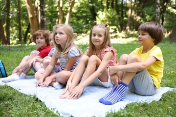 Fototapeta premium Cute little kids on green grass in park