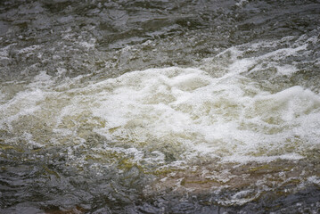 Water flowing in the river, close-up of the water surface
