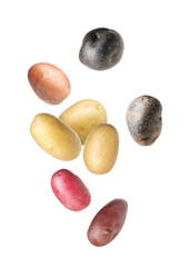 Different types of fresh potatoes falling on white background