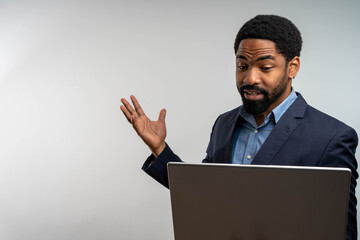 Young businessman holding video conference on laptop at home, isolated with copy space for online...