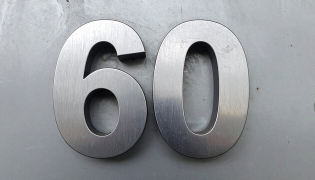 Number 60 forged from shiny steel, polished industrial surface. Strong symbol.