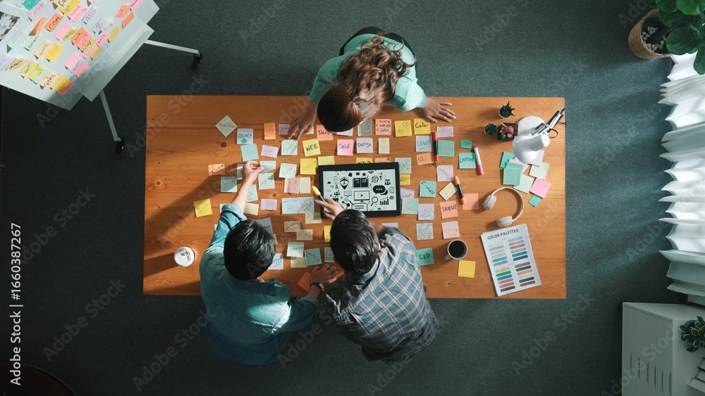 Poster top view of creative designer working together brainstorming idea by using sticky notes at meeting t