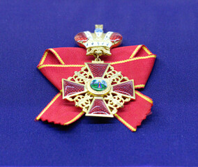 Golden royal order of sahametrei medallion resting on blue velvet