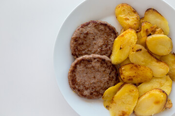Piatto con hamburger e patate arrosto