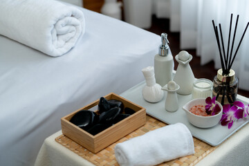 Exquisite display of beauty treatment and spa salon accessories arranged on spa table in luxury spa resort. Relaxing spa massage and recreation background concept. Quiescent