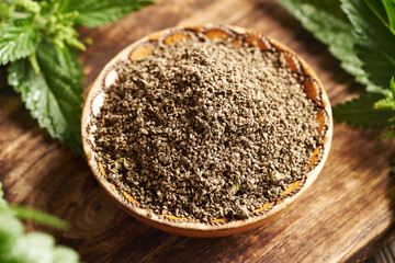 Dry stinging nettle seeds in a wooden bowl