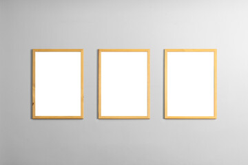 Modern minimal interior with one two three  four  five blank wooden photo frames light gray wall,...