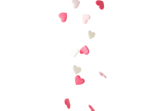 Delightful heart-shaped sprinkles gently falling, creating a whimsical cascade of sweetness, perfect for enchanting celebrations and adding a touch of romance to any festive culinary creation.