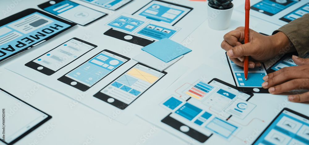 Aufkleber a professional is actively designing a user interface wireframe with paper prototypes in a modern wo