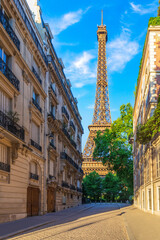Eiffel Tower, famous landmark of Paris, view from a typical street of France
