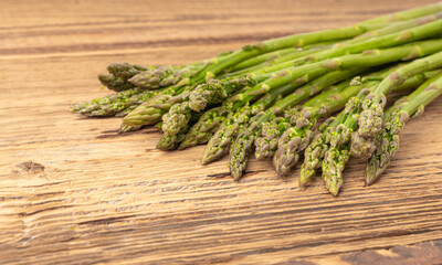 Bunch of Raw Garden Asparagus on Wood Rustic Tabletop. Fresh Green Spring Vegetables
