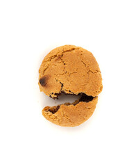 Crumbled chocolate cookies with chocolate filling isolated, brown round biscuits pieces