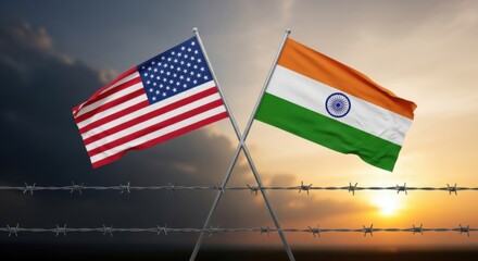 Fototapeta premium USA and India flags crossed over barbed wire, symbolizing sanctions, rising tariffs, trade war, political conflict, and strained international relations