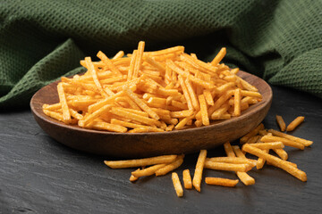 Fried chips sticks, finger potato chips, golden shoestring fries pile, French fries