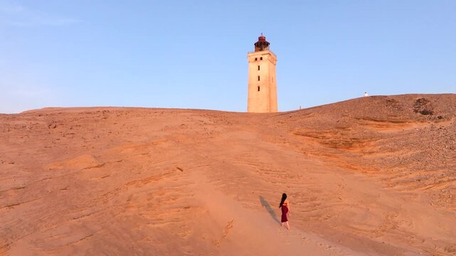 Aerial view of the giant sand dunes with the famous lighthouse on the top of a hill. Rubjerg Knude Lighthouse, , North SeaRubjerg , Sunset at the lighthouse Rubjerg Knude Fyr near Lokken in Denmark. 