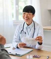 Portrait of a young asian doctor and patient at doctor's office in clinic