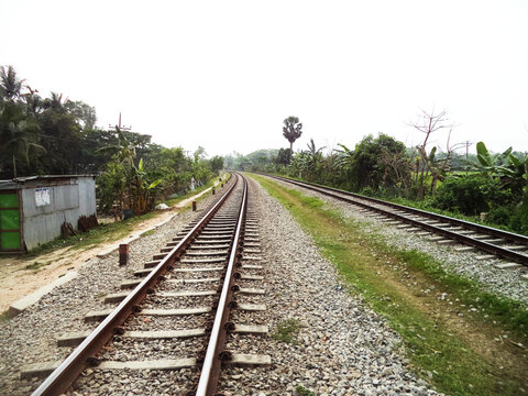Two railway lines surrounded by the green nature of the village.