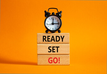 Ready Set Go symbol. Concept words Ready Set Go on wooden blocks. Beautiful orange background with...