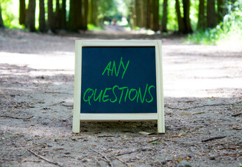 Obraz premium Any Questions symbol. Concept word Any Questions on chalk blackboard. Beautiful forest background. Business and Any Questions concept. Copy space.