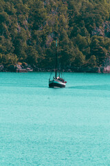 Small wooden sailboat in the sea
