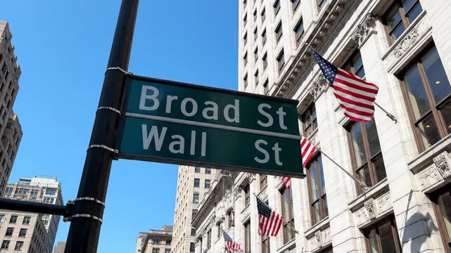 Wall Street and Broad Street Intersection in NYC Financial District - A low-angle view of a street sign marking the intersection of Wall Street and Broad Street in New York City's financial district.