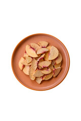 Dried sublimated slices of peach or apricot as an ingredient for sweet desserts. Dried peach