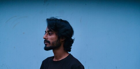 Portrait of a man with blue wall background