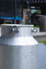 Closeup of old milk jug on a farm