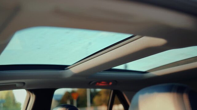 Interior view of modern car cabin with open panoramic glass sunroof and leather headrests under natural daylight &ndash; showcasing premium automotive design, spacious comfort and elegant craftsmanship for 