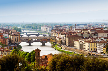 Top panoramic view of Ponte Vecchio bridge on Arno river and old part of Florence, Tuscany, Italy