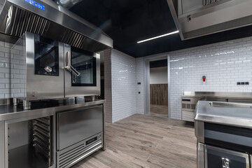 A contemporary kitchen features high-end stainless steel appliances, ample counter space, and a...