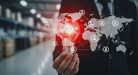 A person holding a lightbulb with a world map and people icons overlaid on the image in a warehouse
