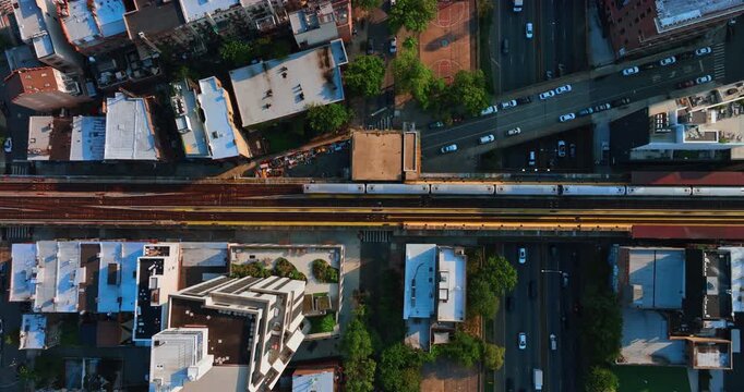 Train moves by the railways. Multiple cars ride by the highway and freeway. Top view. Traffic in New York, USA.