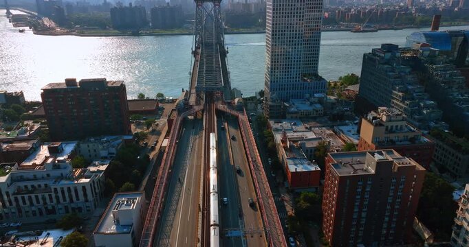 Following a train moving to the Williamsburg Bridge. Hazy skyline of the Lower East Side of Manhattan at backdrop.