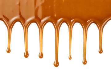 Golden caramel sauce dripping in elegant strands with glossy texture isolated on transparent background