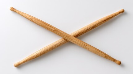 Pair Of Light Brown Wooden Drumsticks Crossed On White Background Studio Shot Overhead View Minimalist Musical Instruments Photography