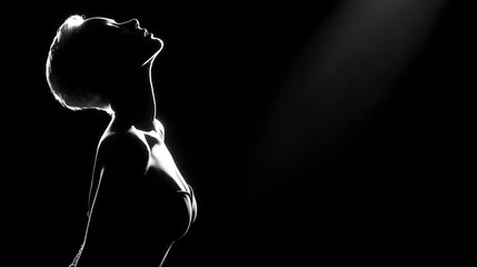 Black and white portrait of a girl on a dark background.