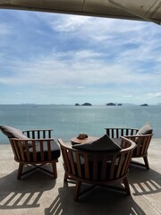 Curved Wooden Terrace Chairs Facing the Sea and Islands