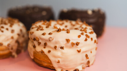 Extreme close-up of a chocolate donut and a white chocolate donut with salted caramel glaze, highlighting texture and decadent details. Perfect for food blogs, dessert menus, and social media content