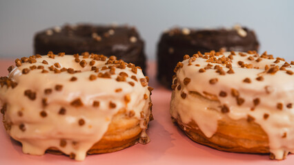 Extreme close-up of a chocolate donut and a white chocolate donut with salted caramel glaze, highlighting texture and decadent details. Perfect for food blogs, dessert menus, and social media content