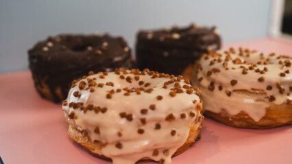 Extreme close-up of a chocolate donut and a white chocolate donut with salted caramel glaze, highlighting texture and decadent details. Perfect for food blogs, dessert menus, and social media content