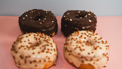 Extreme close-up of a chocolate donut and a white chocolate donut with salted caramel glaze, highlighting texture and decadent details. Perfect for food blogs, dessert menus, and social media content