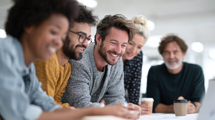 Fototapeta premium A diverse group of professionals collaborates happily on a project, showcasing teamwork, creativity, and a positive work environment. Ideal for business, innovation, and success.