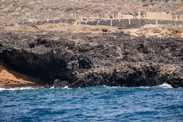 Rugged coastal landscape with volcanic rocks and ocean waves