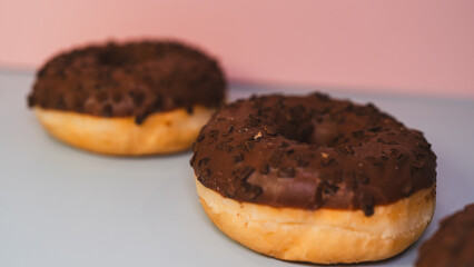 Extreme close-up of a chocolate donut and a white chocolate donut with salted caramel glaze, highlighting texture and decadent details. Perfect for food blogs, dessert menus, and social media content